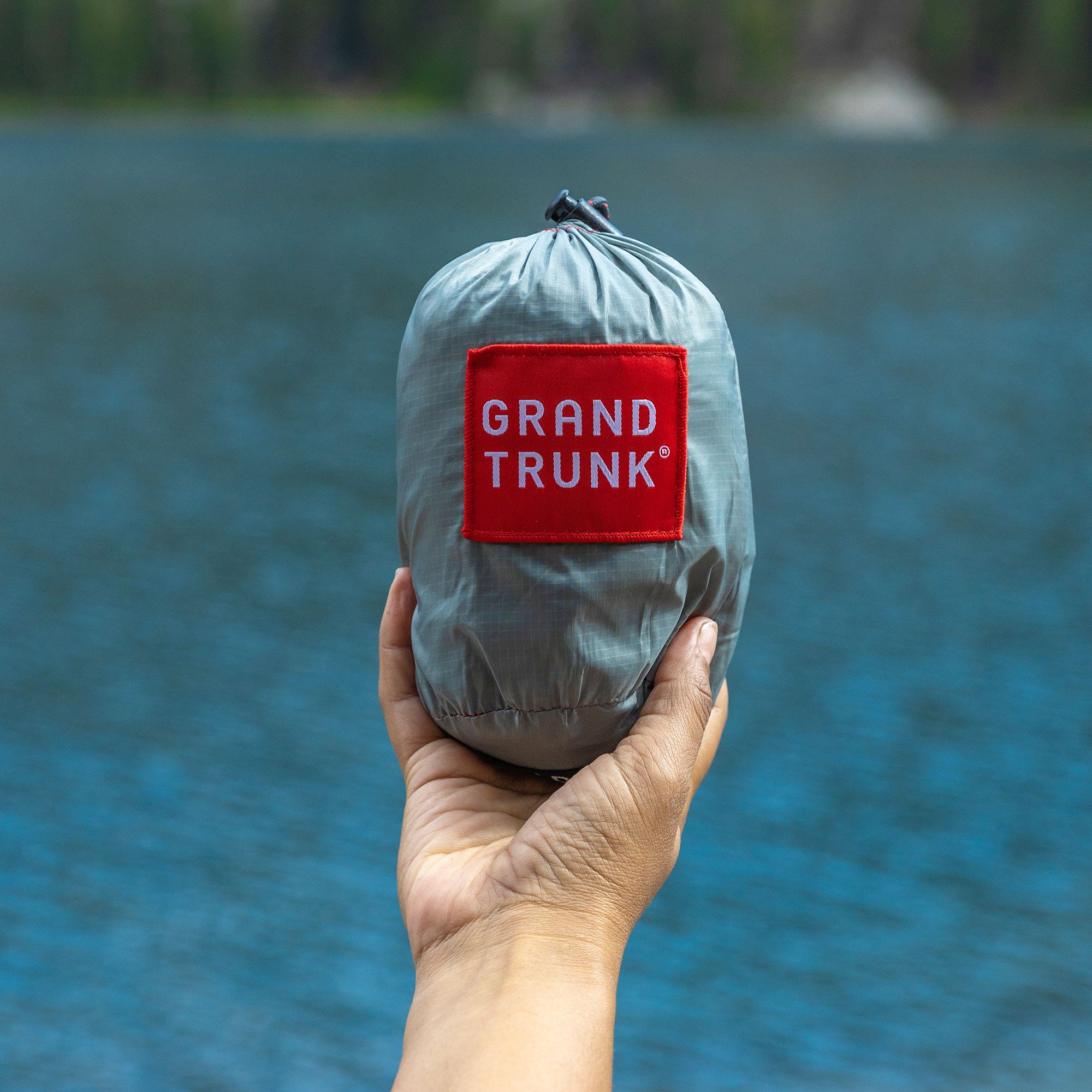 Hand holding Nano 7 Hammock in stuff sack