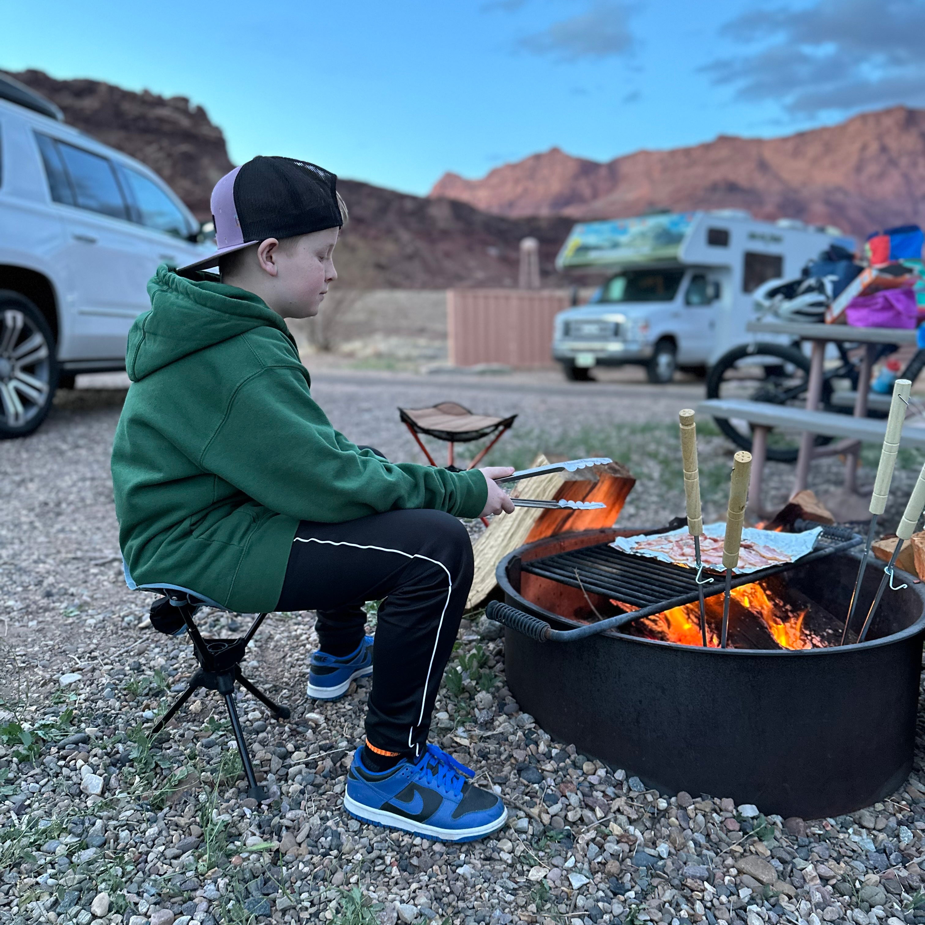 child cooking on fire while sitting in stool
